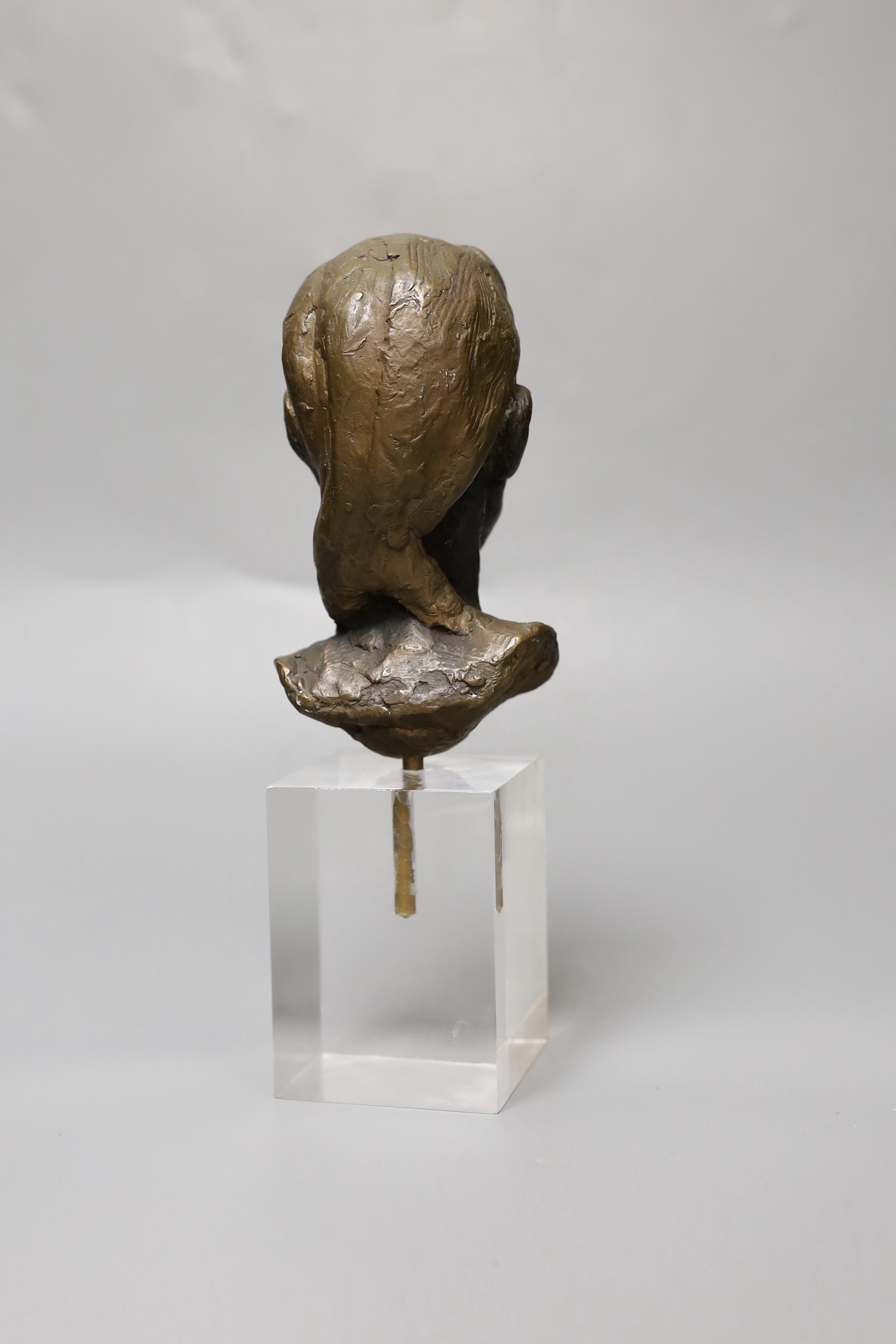 An abstract bronze bust of a girl, on perspex plinth, 24cm